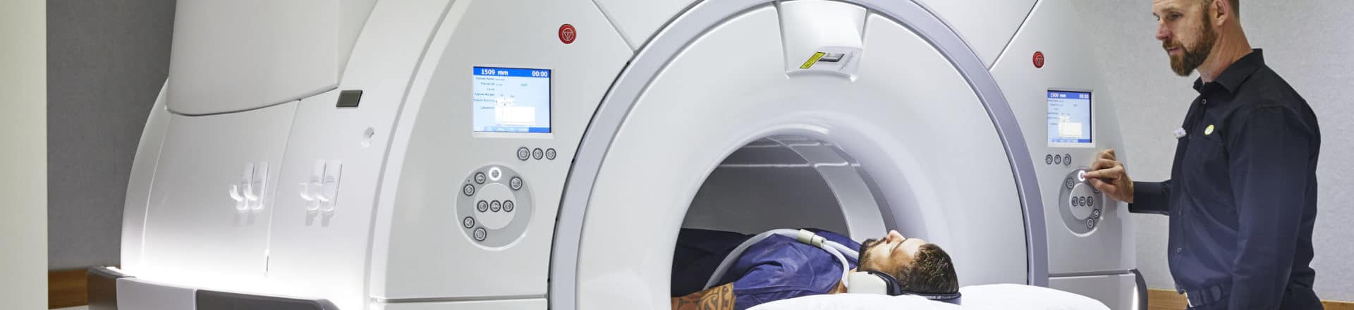 Patient undergoing MRI scan, supervised by expert operator