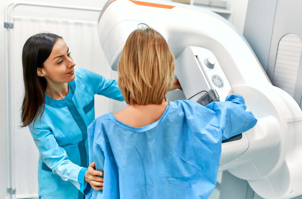 a patient undergoing X-ray examination of the breasts