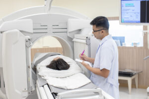 a Technologist next to a patient in a PET scan