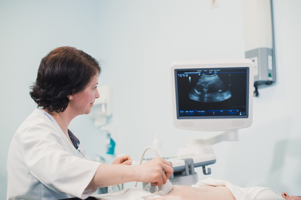 a doctor examining patient with an Ultrasound device