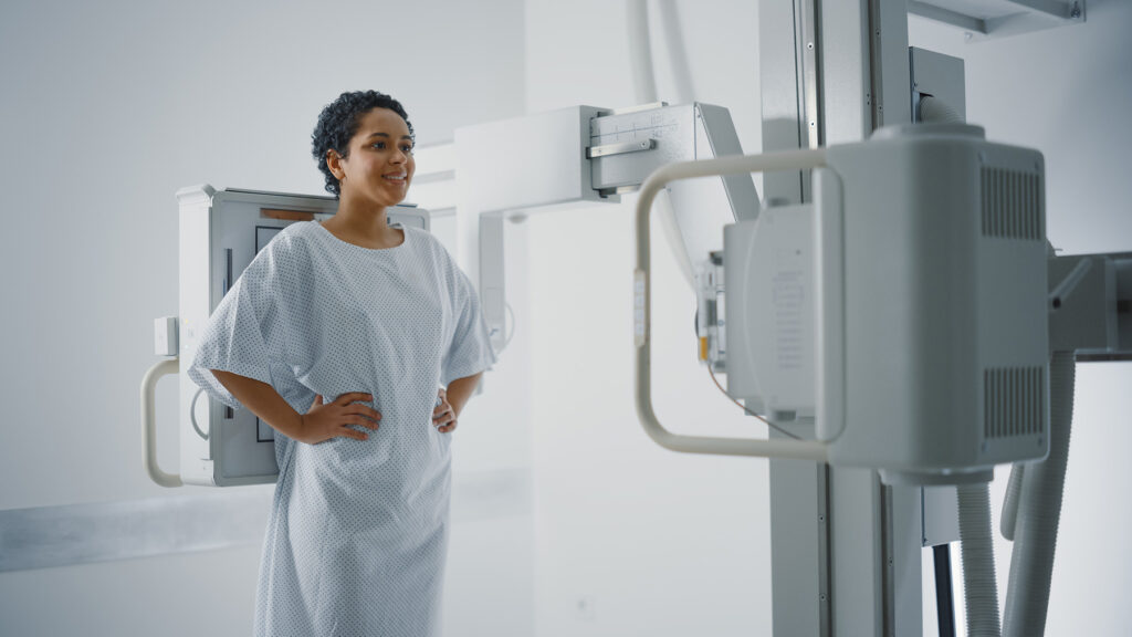 a patient standing for an Xray screening